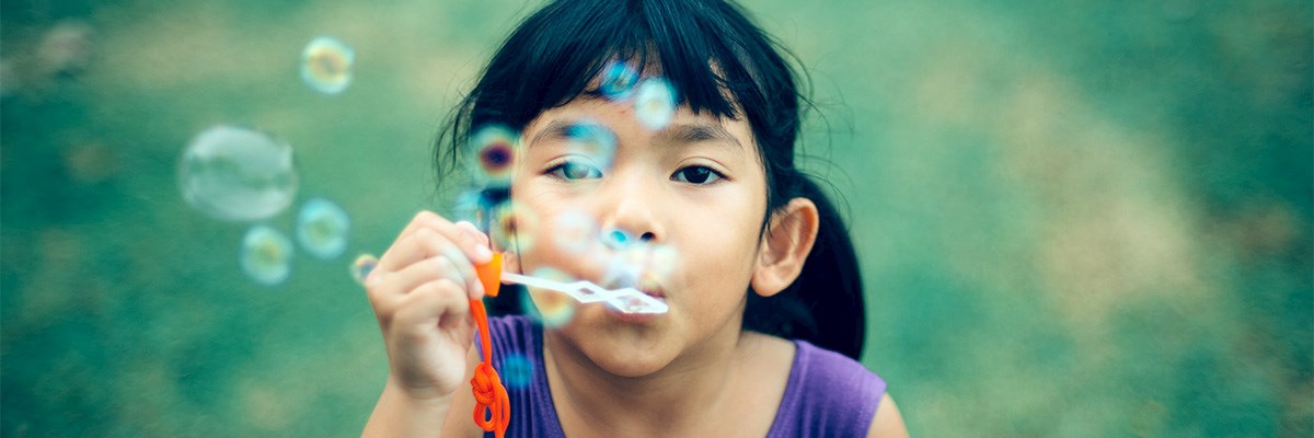 Girl Blowing Bubbles outdoors